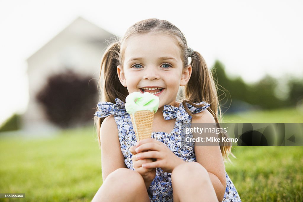 Caucasian girl eating ice cream outdoors