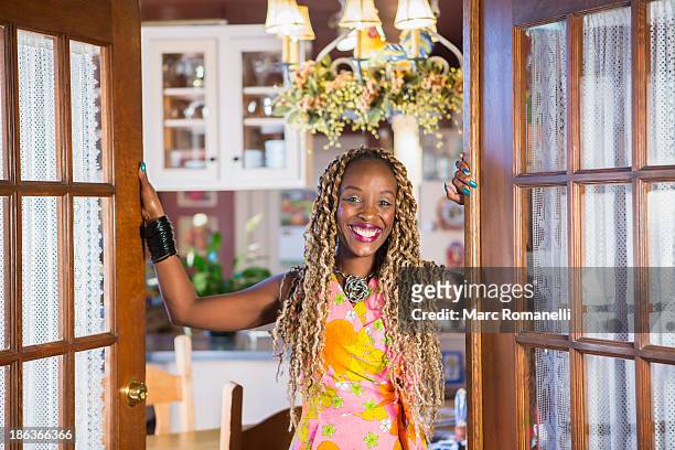 african american woman standing in doorway - one mid adult woman only stock pictures, royalty-free photos & images