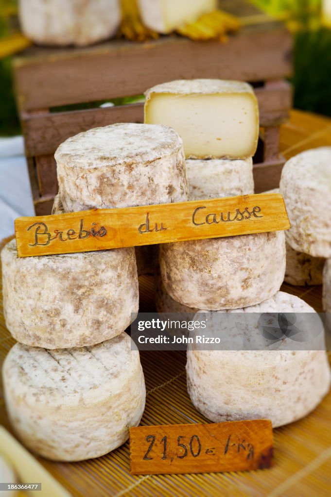 Wheels of cheese for sale in market