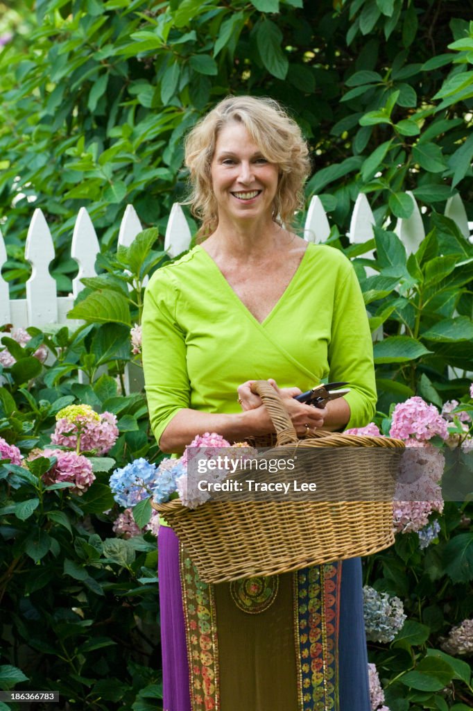 Caucasian woman gathering flowers