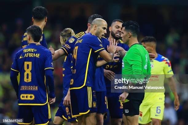 Referee Adonai Escobedo argues with players of Tigres UANL during the final second leg match between America and Tigres UANL as part of the Torneo...