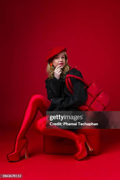 fashionable woman on plain background - red boot stock pictures, royalty-free photos & images