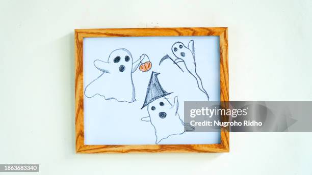 halloween funny ghost cartoon crayon drawing in wooden frame hanging on wall - halloween poster stock pictures, royalty-free photos & images