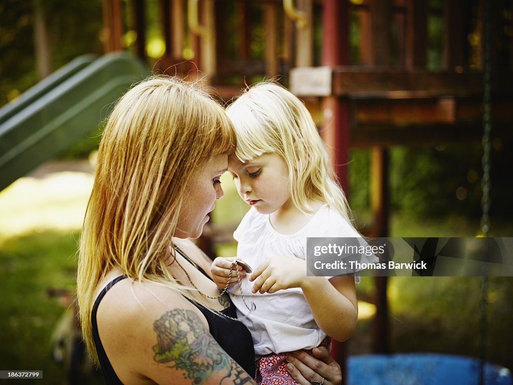 Young daughter being held by mother