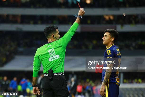 Referee Adonai Escobedo shows the red card to Raymundo Fulgencio of Tigres UANL during the final second leg match between America and Tigres UANL as...