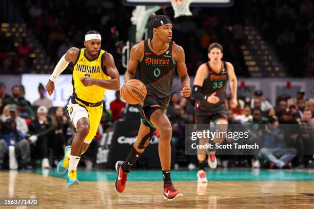 Bilal Coulibaly of the Washington Wizards brings the ball up court in front of Buddy Hield of the Indiana Pacers and Mike Muscala of the Washington...