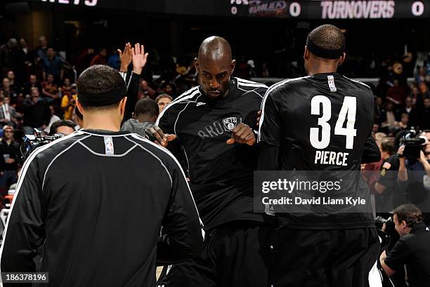 Kevin Garnett of the Brooklyn Nets takes to the court during introductions amongst Deron Williams and Paul Pierce prior to the game against the...