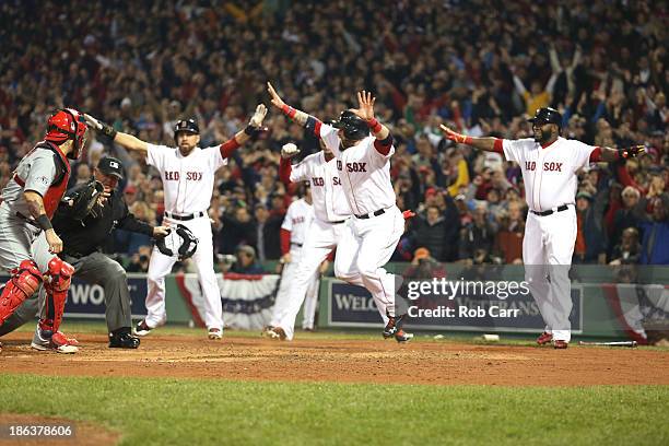 Jonny Gomes of the Boston Red Sox celebrates after sliding safely into home plate in the third inning against the St. Louis Cardinals during Game Six...