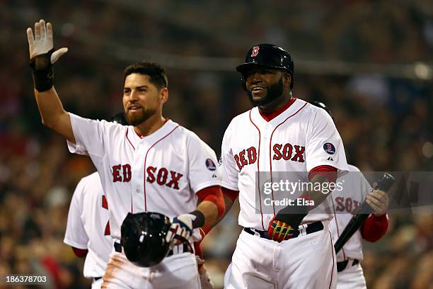 David Ortiz and Jacoby Ellsbury of the Boston Red Sox return to the dugout after scoring in the third inning against the St. Louis Cardinals during...