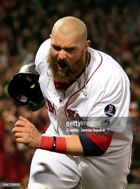 Jonny Gomes of the Boston Red Sox celebrates after scoring in the third inning on a hit by Shane Victorino against the St. Louis Cardinals during...