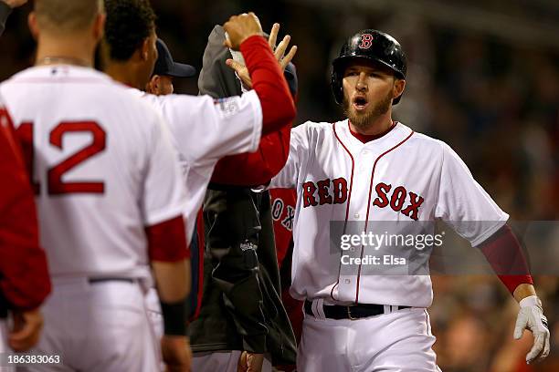 Stephen Drew of the Boston Red Sox returns to the dugout after hitting a home run in the fourth inning against the St. Louis Cardinals during Game...