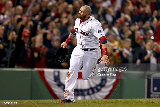 Jonny Gomes of the Boston Red Sox celebrates after scoring in the third inning on a hit by Shane Victorino against the St. Louis Cardinals during...