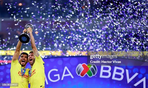 Henry Martin and Miguel Layun of America lift the champions trophy after winning the final second leg match between America and Tigres UANL as part...