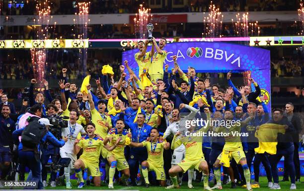 Henry Martin and Miguel Layun of America lift the champions trophy after winning the final second leg match between America and Tigres UANL as part...