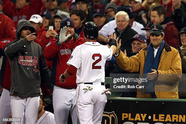 Jacoby Ellsbury of the Boston Red Sox celebrates a run with U.S. Secretary of State John Kerry during Game Six of the 2013 World Series against the...