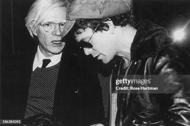 American Pop artist Andy Warhol speaks with singer and musician Lou Reed durin an event in the Studio 54 nightclub, New York, New York, 1977.