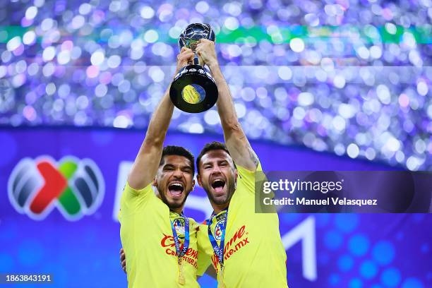 Henry Martin and Miguel Layun of America lift the champions trophy after winning the final second leg match between America and Tigres UANL as part...