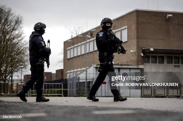 Armed police officers patrol around the outside of 'The Bunker', an extra secure court, ahead of a pro forma hearing in "The Marengo Trial", in...
