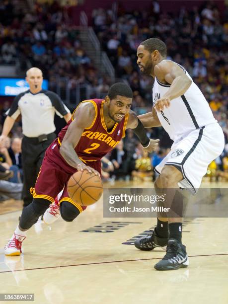 Kyrie Irving of the Cleveland Cavaliers drives past Alan Anderson of the Brooklyn Nets during the second half at Quicken Loans Arena on October 30,...