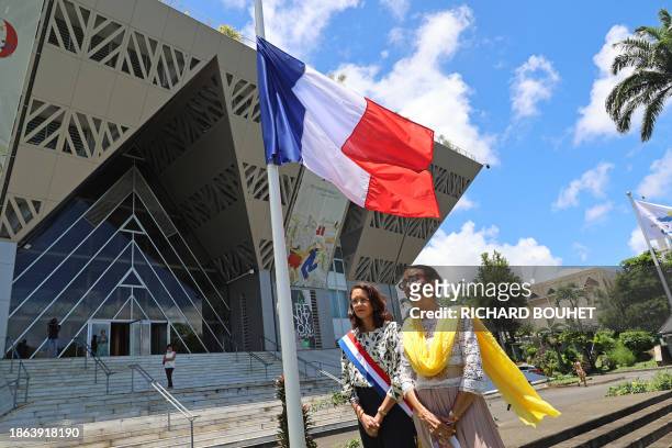 Regional Council President Huguette Bello and French Senator Evelyne Corbieres stand next to a French national flag at half-mast following the...