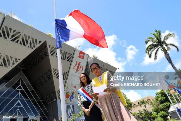 Regional Council President Huguette Bello and French Senator Evelyne Corbieres stand next to a French national flag at half-mast following the...