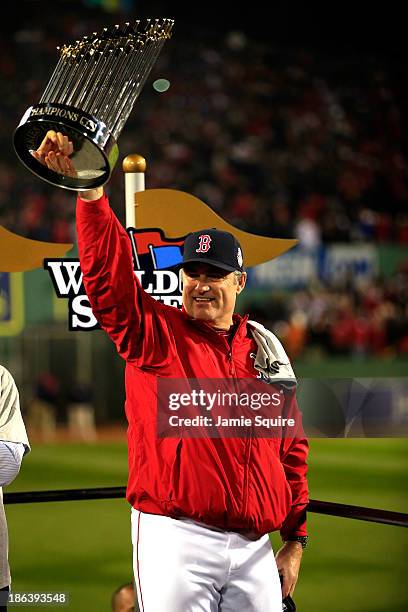 Manager John Farrell of the Boston Red Sox holds up the World Series trophy after defeating the St. Louis Cardinals 6-1 in Game Six of the 2013 World...