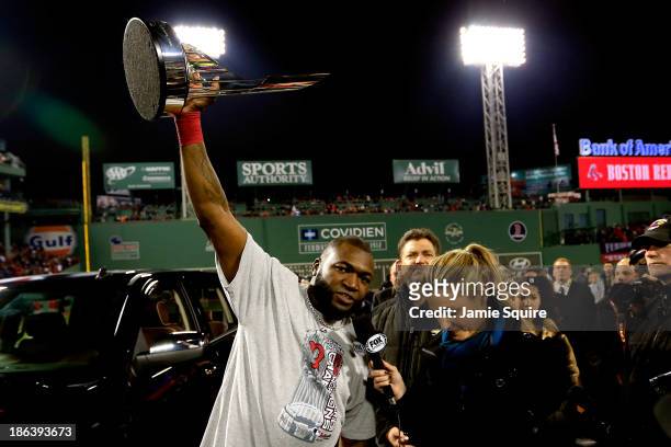 David Ortiz of the Boston Red Sox holds up the MVP trophy following a 6-1 victory over the St. Louis Cardinals in Game Six of the 2013 World Series...