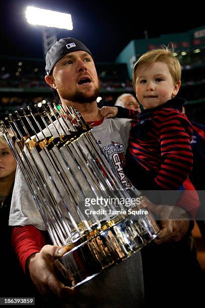 Jon Lester of the Boston Red Sox celebrates with his son Hudson after defeating the St. Louis Cardinals 6-1 in Game Six of the 2013 World Series at...