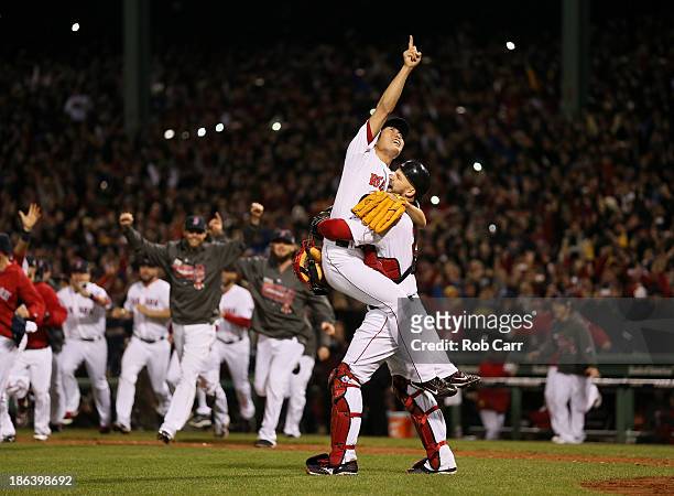 Koji Uehara of the Boston Red Sox celebrates with David Ross after defeating the St. Louis Cardinals 6-1 in Game Six of the 2013 World Series at...