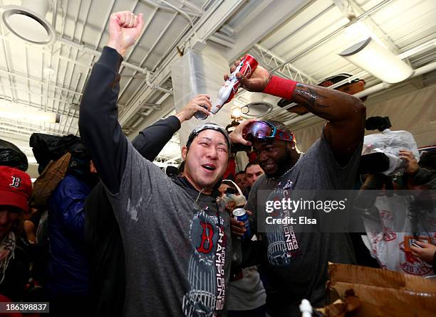 Junichi Tazawa and David Ortiz of the Boston Red Sox celebrate in the locker room following a 6-1 victory over the St. Louis Cardinals in Game Six of...