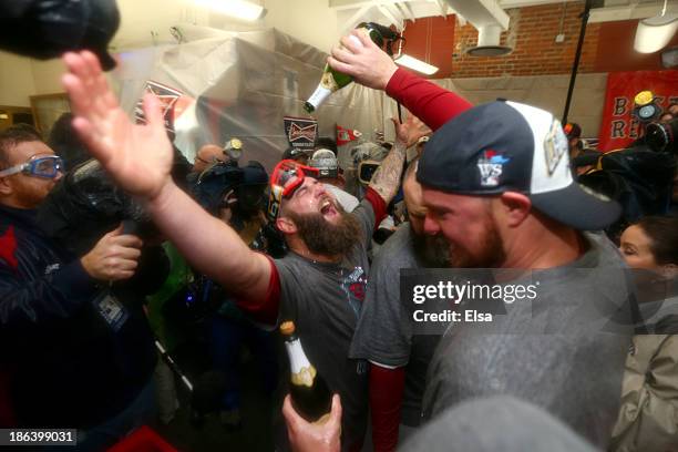 Mike Napoli of the Boston Red Sox celebrates in the locker room after defeating the St. Louis Cardinals 6-1 in Game Six of the 2013 World Series at...