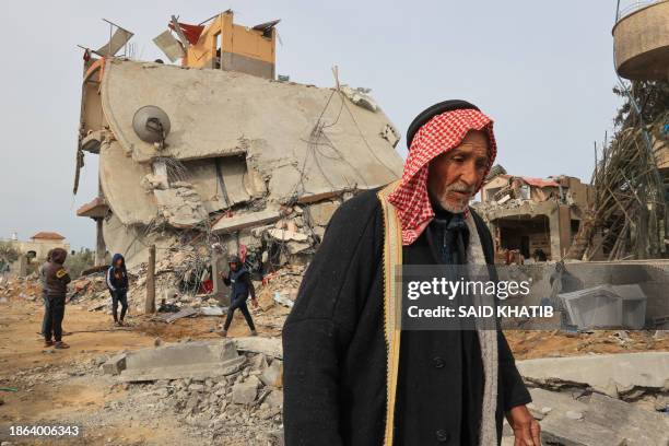 Palestinians check the rubble following Israeli bombardment in Khan Yunis in the southern Gaza Strip on December 21 amid continuing battles between...