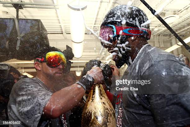 Jacoby Ellsbury and David Ortiz of the Boston Red Sox celebrate in the locker room after defeating the St. Louis Cardinals 6-1 in Game Six of the...