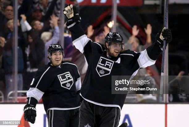 Anze Kopitar of the Los Angeles Kings celebrates with Drew Doughty after Kopitar scored the game winning goal in overtime with an assist from Doughty...