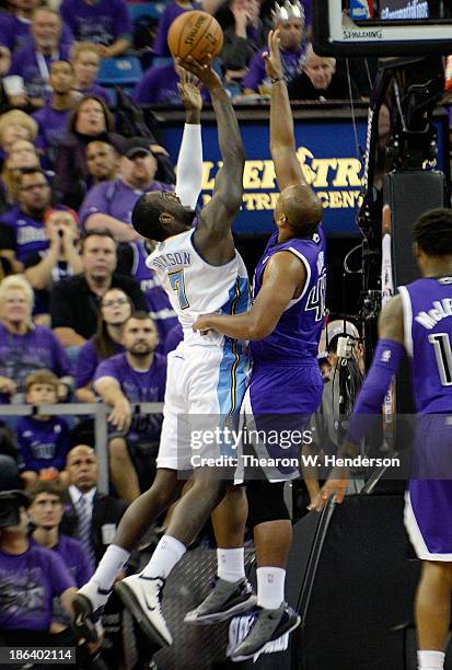 Hickson of the Denver Nuggets shoots over Chuck Hayes of the Sacramento Kings during the third quarter at Sleep Train Arena on October 30, 2013 in...