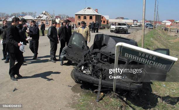 Investigators examine the armored Mercedes car used by Ingushetia's President Murat Zyazikov that was damaged after his entourage was rammed by a car...