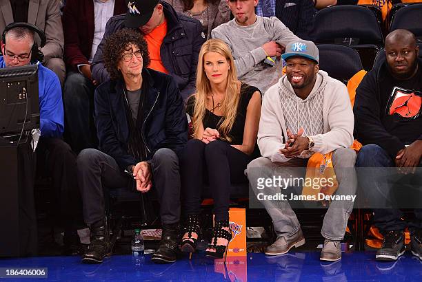 Howard Stern, Beth Ostrosky and 50 Cent attend the Milwaukee Bucks vs. The New York Knicks at Madison Square Garden on October 30, 2013 in New York...