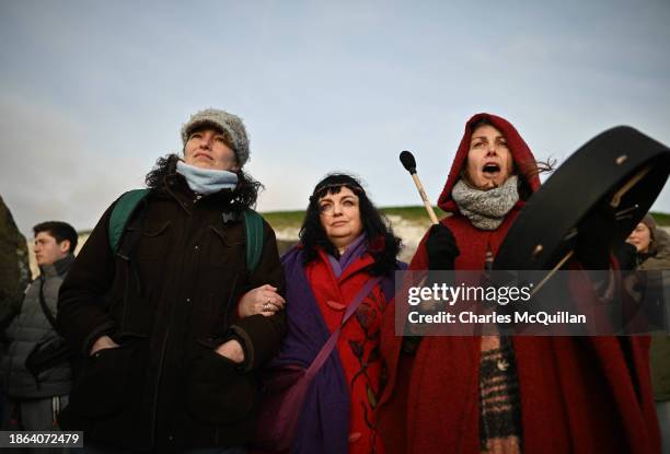 Gathering of people celebrate by singing and dancing as the sun rises during the Winter Solstice at Newgrange on December 21, 2023 in Newgrange,...