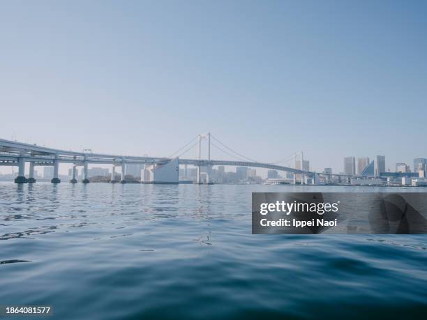 tokyo rainbow bridge seen from boat - chuo ward tokyo stock pictures, royalty-free photos & images