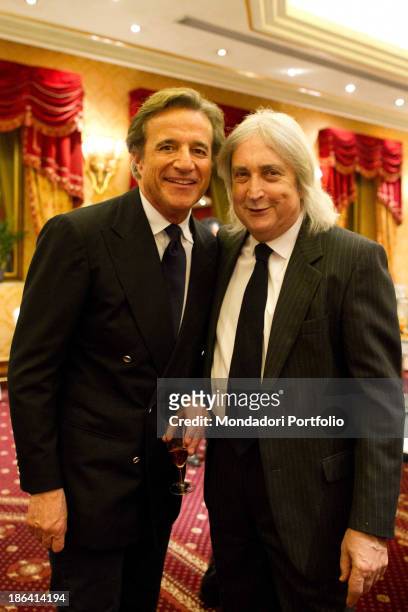 Italian actor, director and singer Christian De Sica smiling beside Italian scriptwriter and producer Enrico Vanzina during the reception at the...