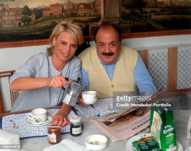 Italian Tv presenter Maria De Filippi pouring coffee to her husband and Italian journalist and TV host Maurizio Costanzo. 1995.