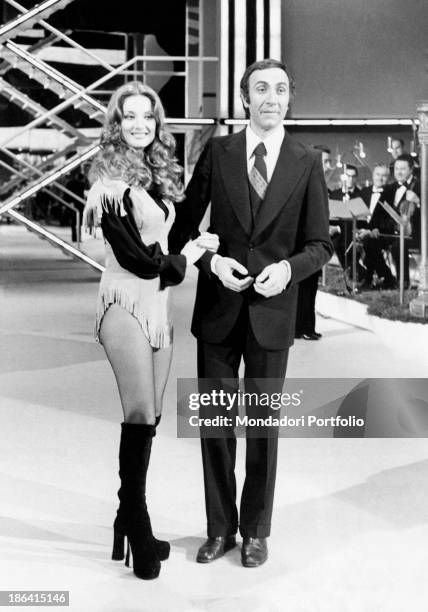 The German actress Barbara Bouchet on the stage of Canzonissima, arm in arm with the hosting Pippo Baudo; Bouchet, muse of the Italian cinema,...