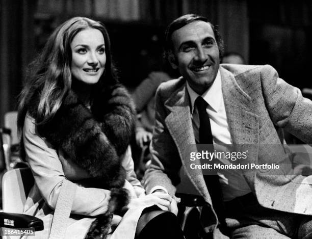 Barbara Bouchet sitting on the stage of the music festival Canzonissima beside the hosting, a smiling Pippo Baudo; the German actress, born Barbara...