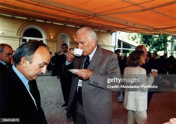 Italian manager and president of the FIAT Paolo Fresco having a cup of tea at the Ambrosetti International Forum in Villa d'Este. On the left there...