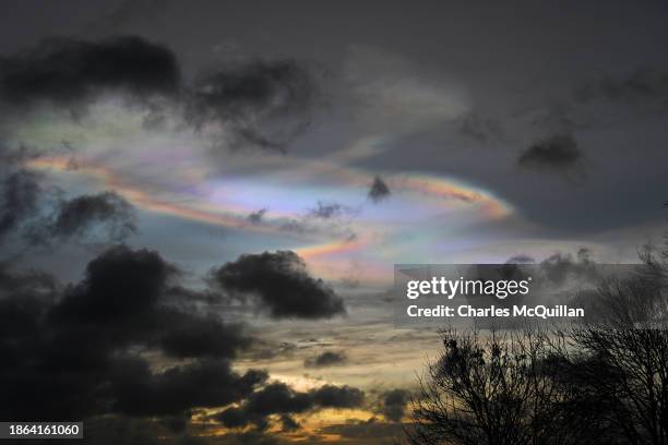 The sun rises with a rainbow effect as people watch on during the Winter Solstice at Newgrange on December 21, 2023 in Newgrange, Ireland. Newgrange,...
