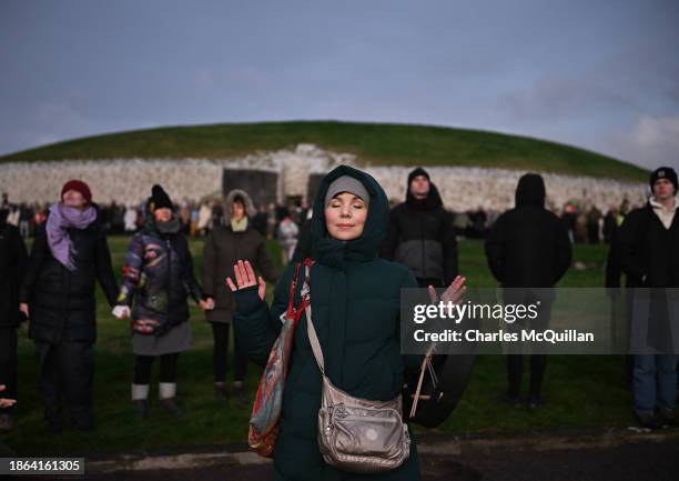 People take part in a sun rise ceremony during the Winter Solstice at Newgrange on December 21, 2023 in Newgrange, Ireland. Newgrange, a...