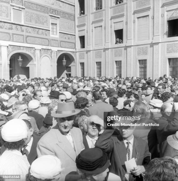 Large group of people stopping in the main courtyard of the Prince's Palace of Monaco after attending the baptism of Prince Albert II of Monaco....