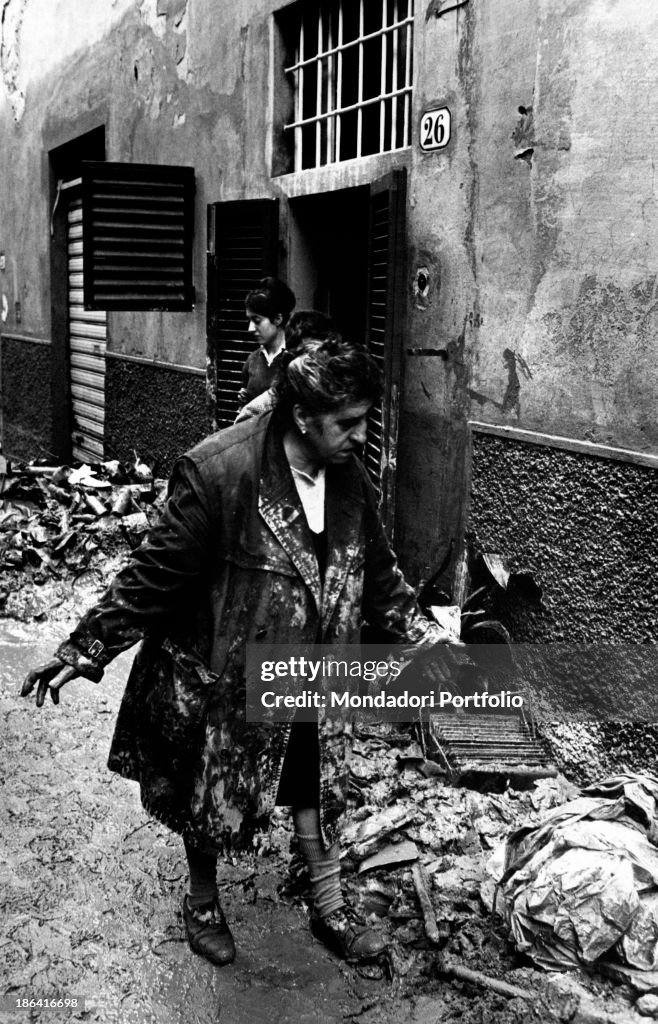 Woman looking at the damages caused to her house