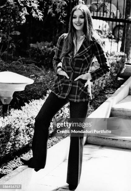 The German actress Barbara Bouchet, an emerging face of the Italian comedy, posing smiling in a garden. Rome , 1972.