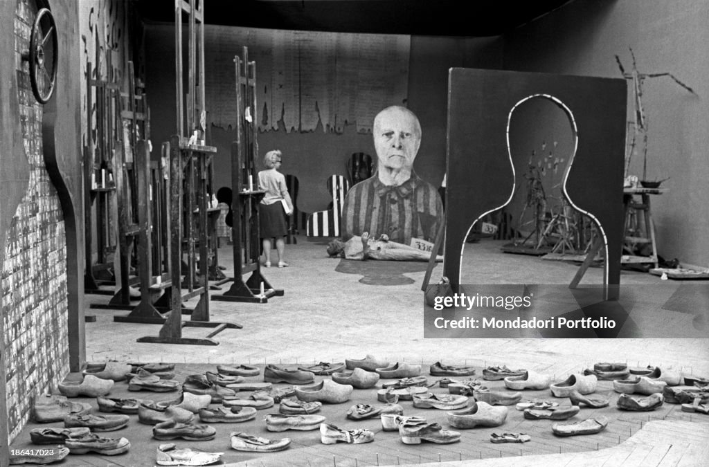 A woman observing Reminiscences by Jozef Szajna at the 35th Venice Biennale